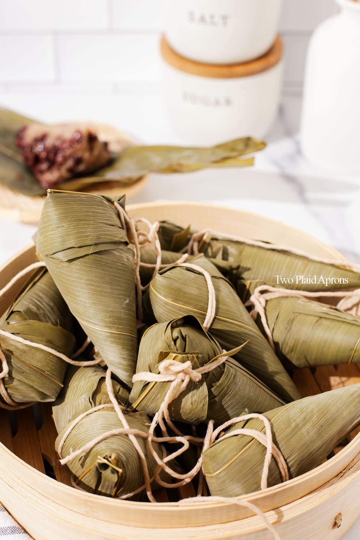 Zongzi cooked and sitting in bamboo basket.