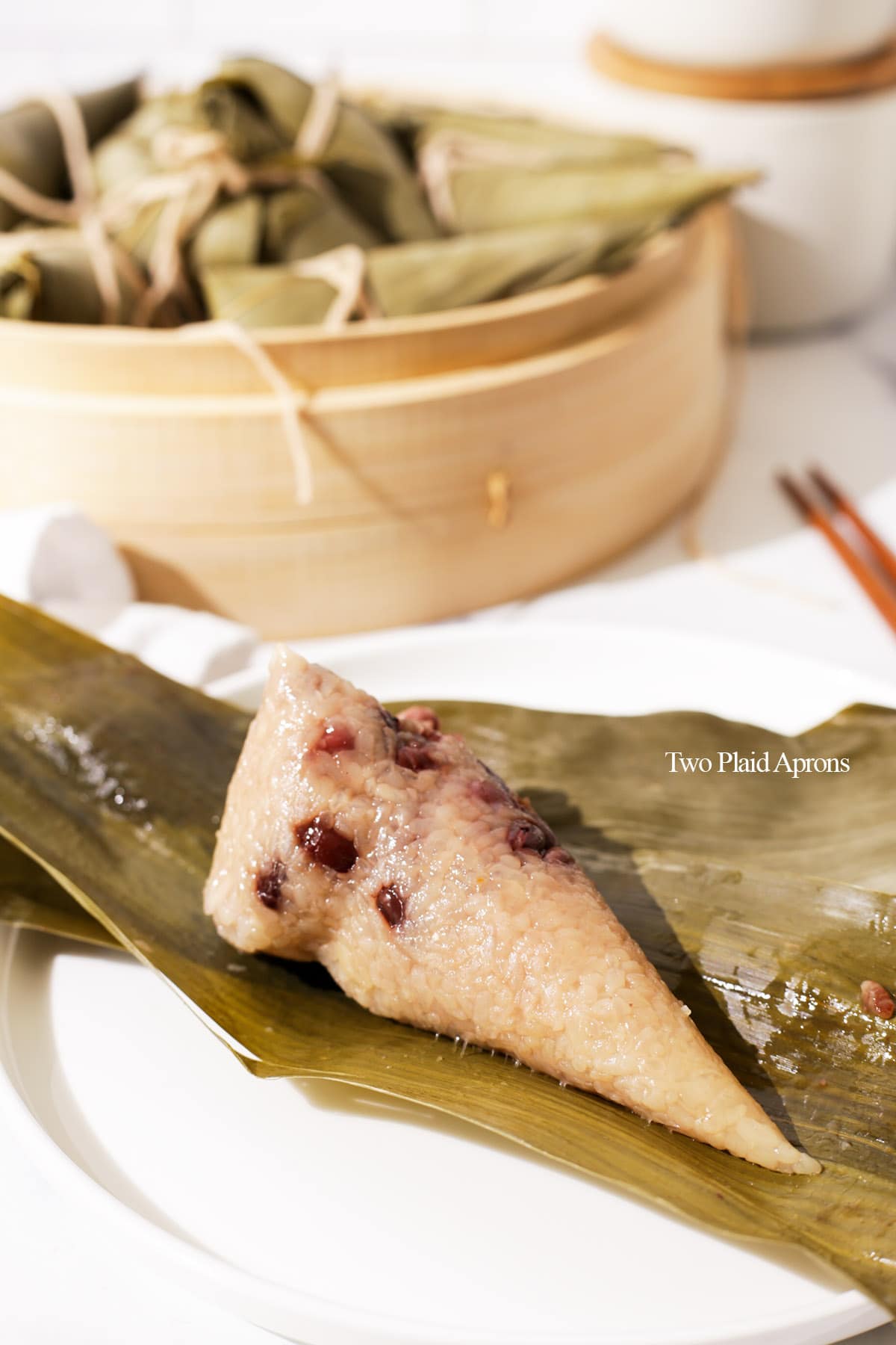 Zongzi with red beans on plate unwrapped.