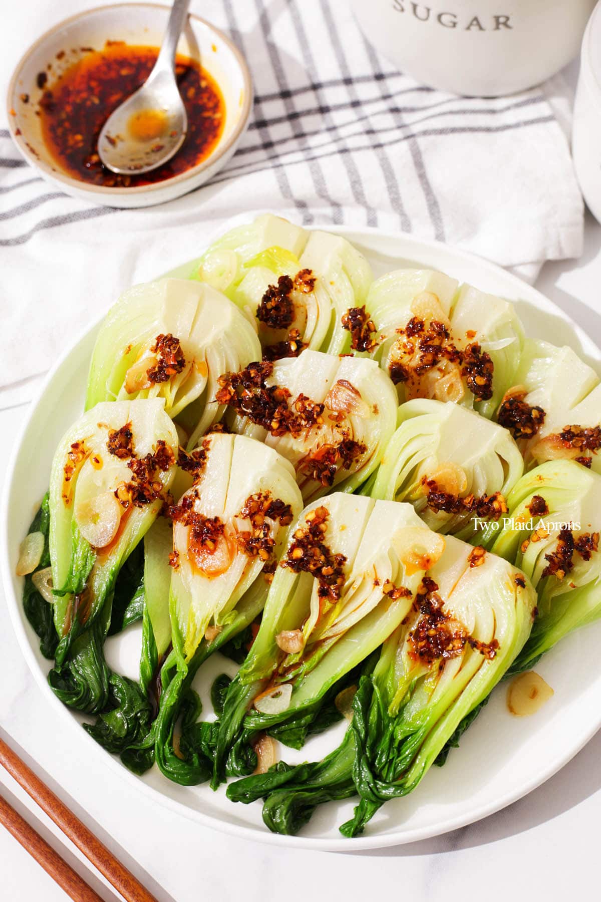 Garlic bok choy with chili oil on a plate.