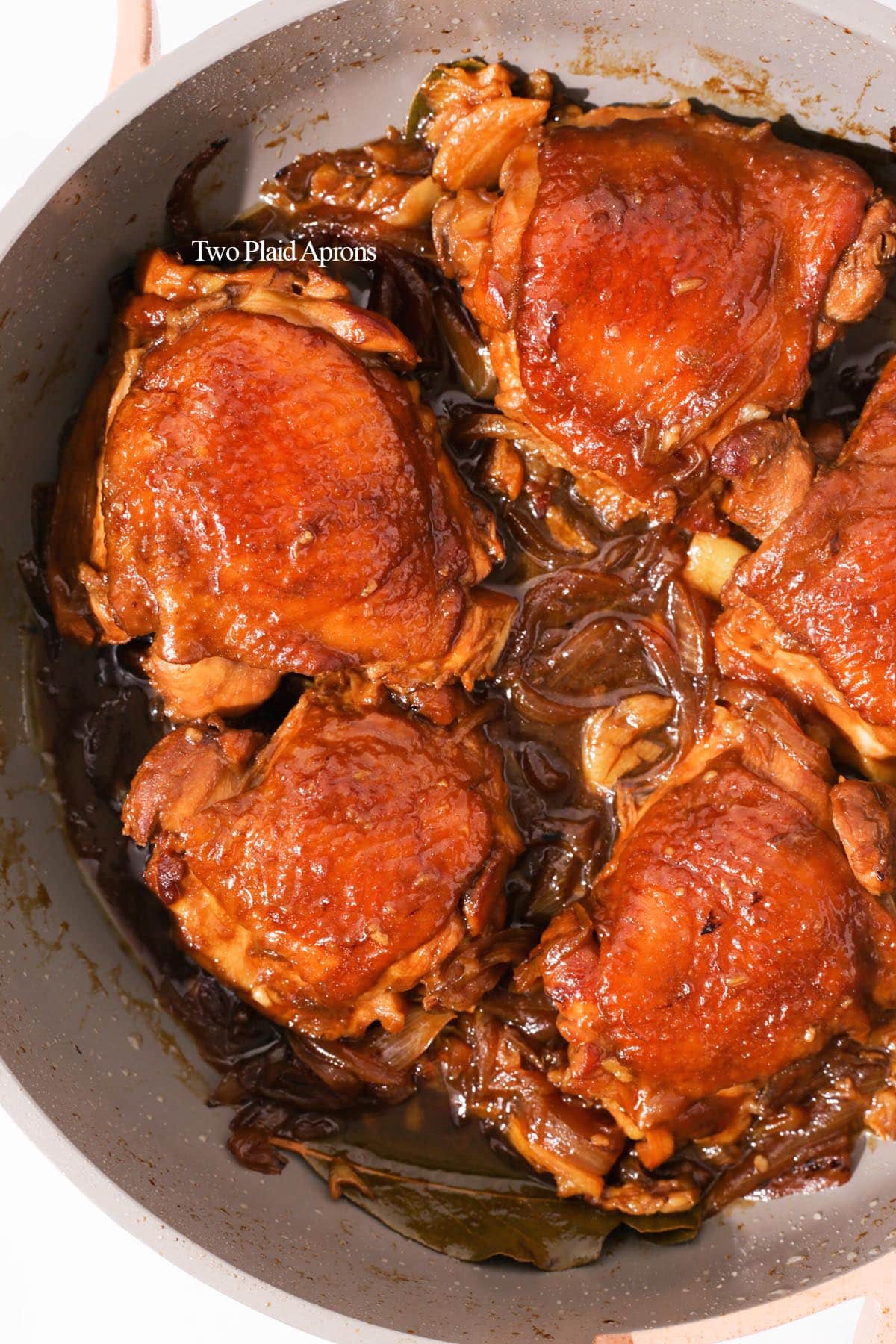 Chicken adobo cooked in pan.