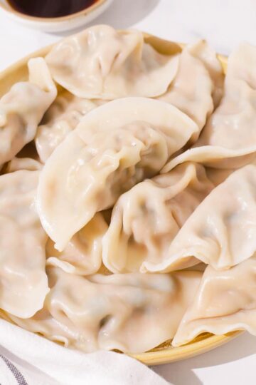 A plate of boiled pork and chive dumplings.
