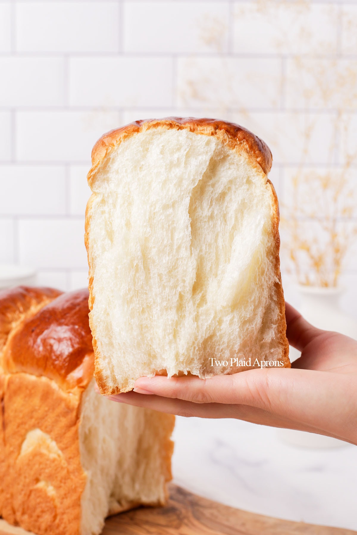 https://twoplaidaprons.com/wp-content/uploads/2022/10/holding-the-Japanese-milk-bread.jpg
