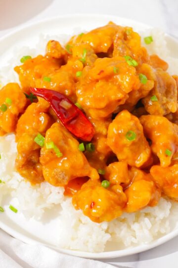 Orange chicken on a bed of rice.