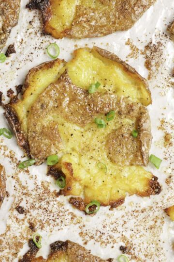 Crispy smashed potato garnished with green onions.