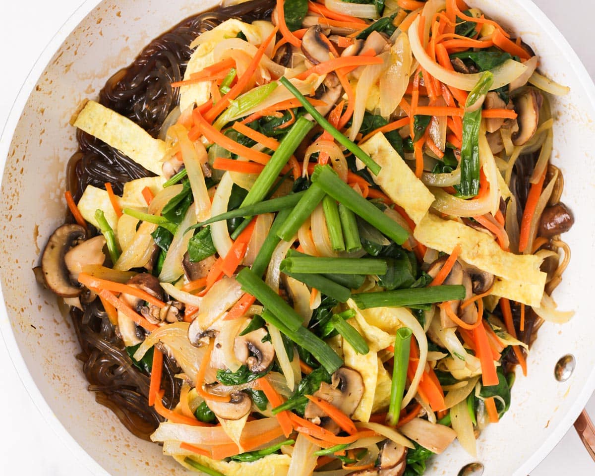 The rest of japchae ingredients added to the sweet potato noodles.