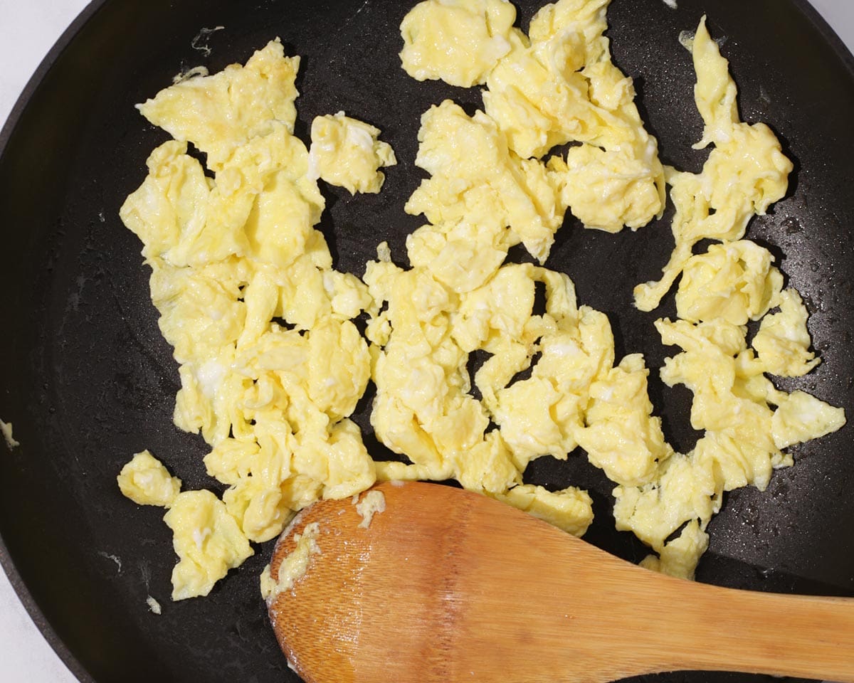 Cooking eggs in pan.