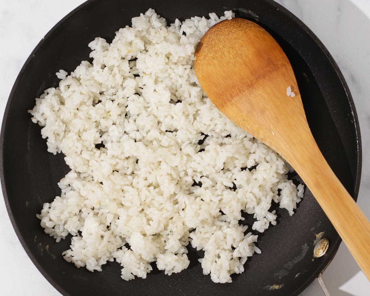 Cooking rice in pan.