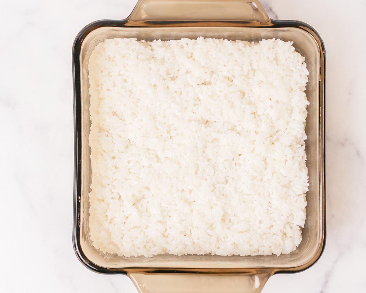 Layering cooked rice in baking dish.