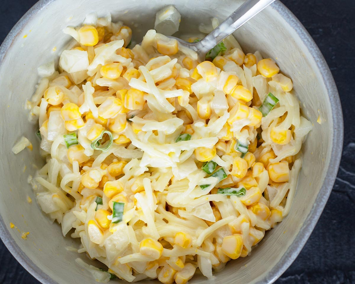 Mixing the hotdog bread topping together in a bowl.