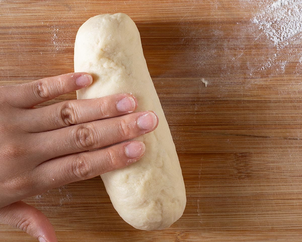 Rolling the dough with the hotdog.