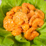 Bang bang shrimp on plate with lettuce thumbnail shot.
