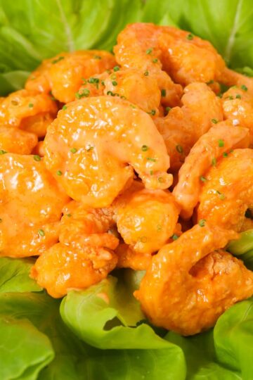 Bang bang shrimp on plate with lettuce thumbnail shot.