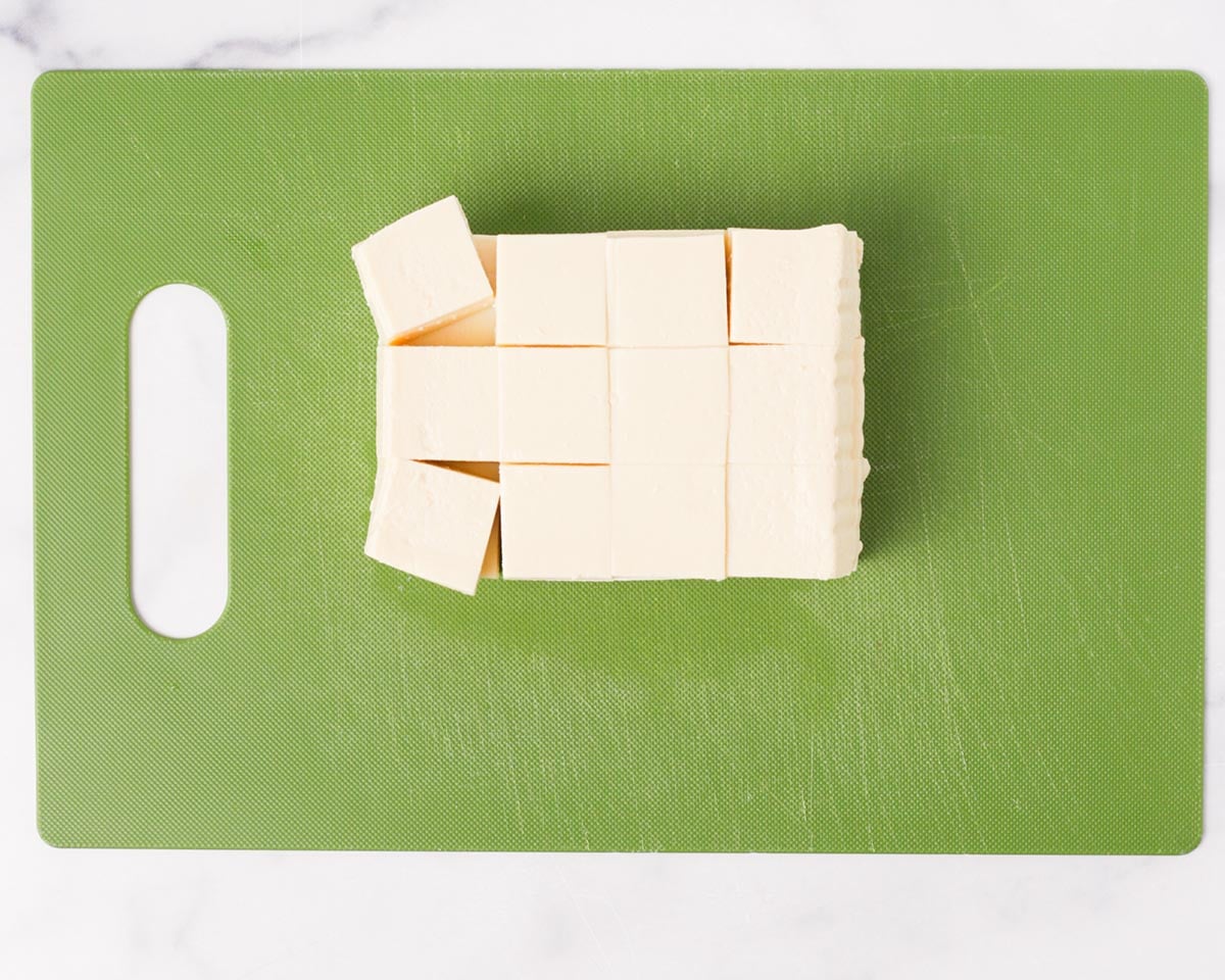 Cutting the tofu into cubes.