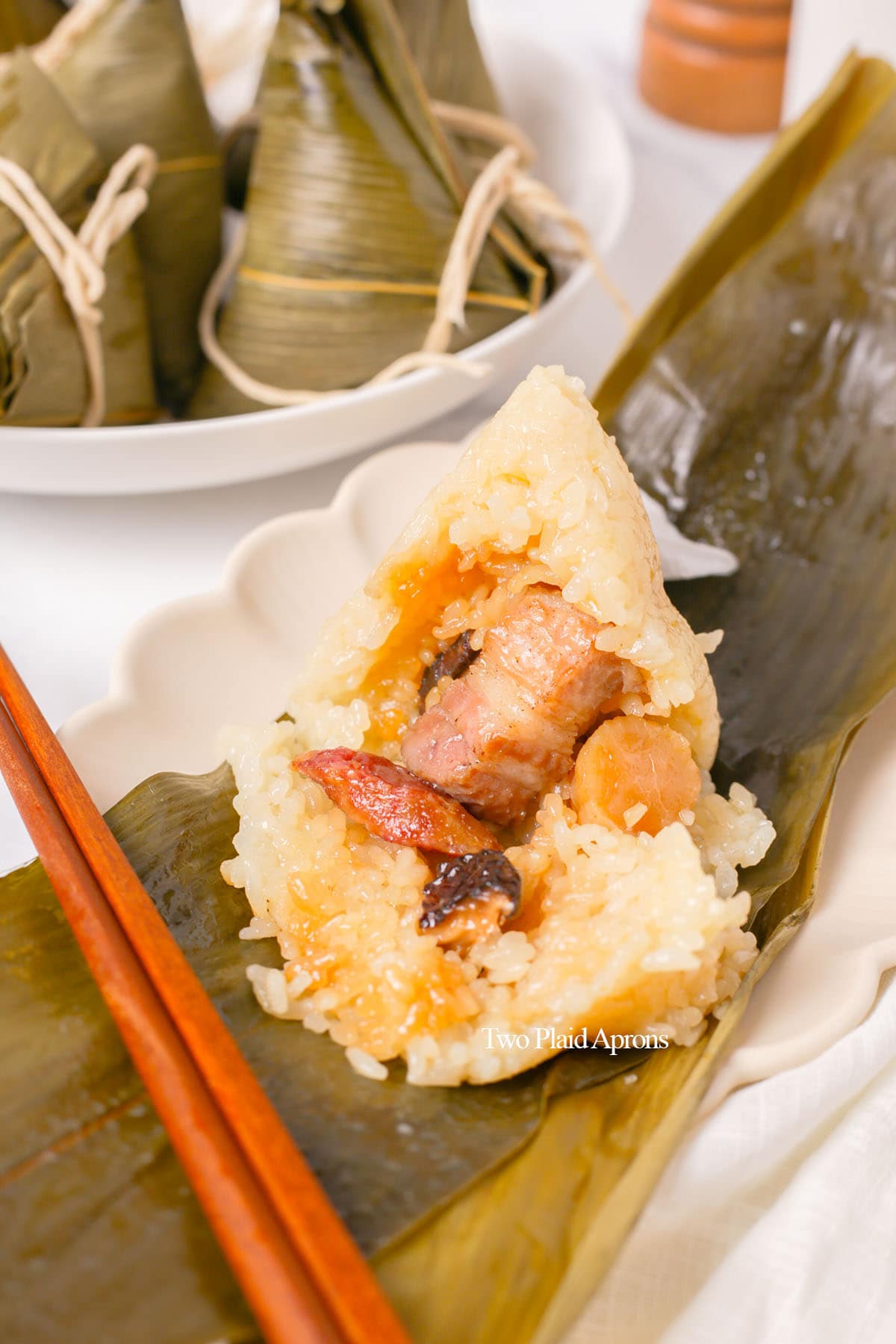 Zongzi with rice opened to show filling.