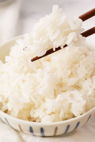 Picking up rice in a bowl thumbnail shot.