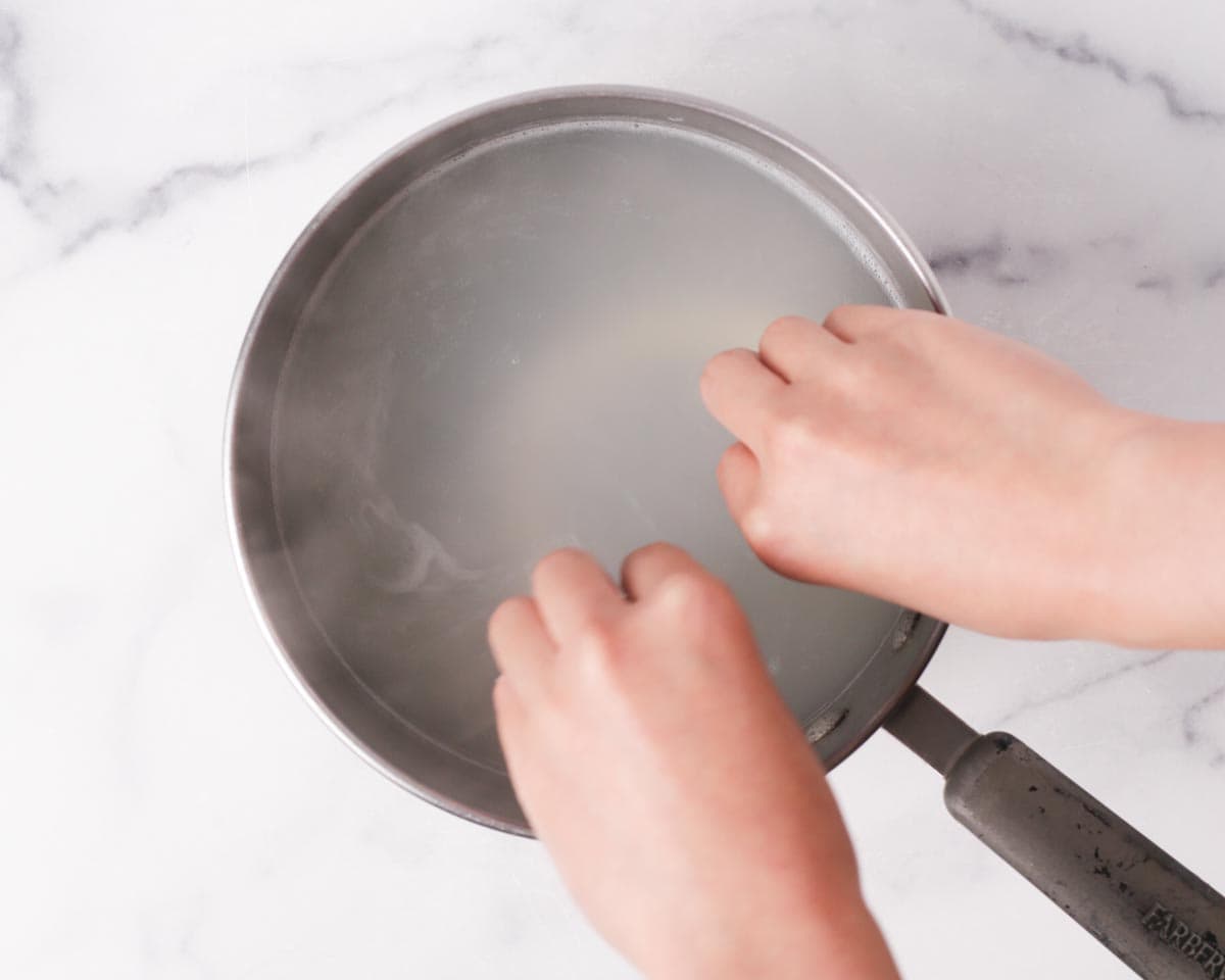 Dropping the potato noodles into boiling water.