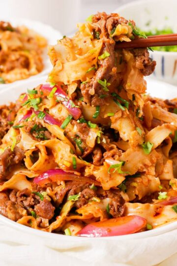 Picking up chopsticks full of cumin lamb noodles.