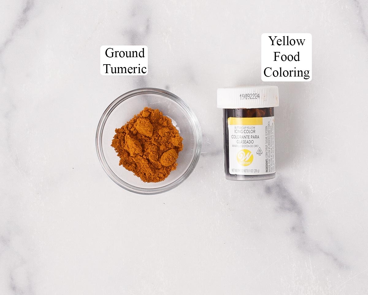 Showing ground turmeric and yellow food coloring next to each other.