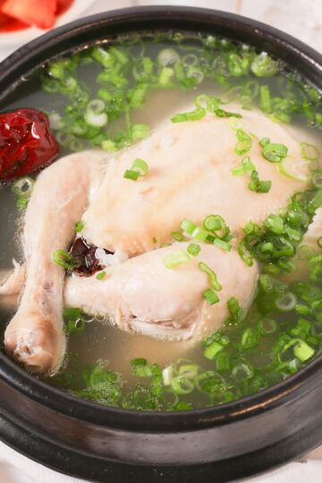 A bowl of samgyetang with green onions.