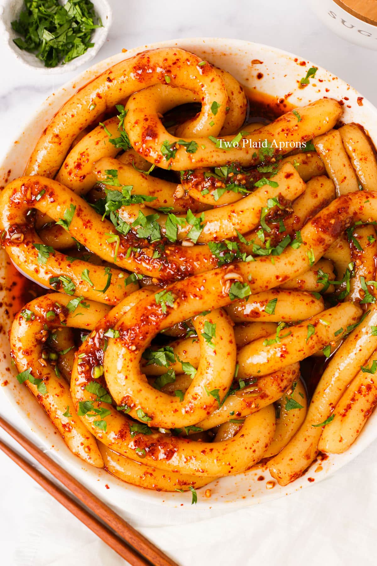 Top down of a plate of spicy potato noodles.