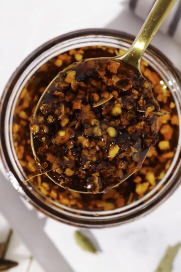 A top down view of a spoonful of Chinese chili oil.