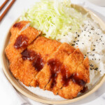 Chicken katsu on a plate.
