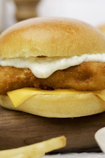 A homemade Filet-O-Fish sandwich on a cutting board.