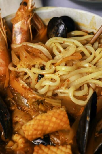 Jjamppong with noodles, shrimps, squid, and mussels.