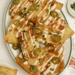Crab rangoon nachos on a plate with one torn open.