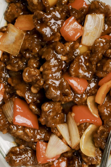 Beijing Beef on a plate with a spoon.