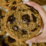 Holding a brown butter chocolate chip cookie in hand.