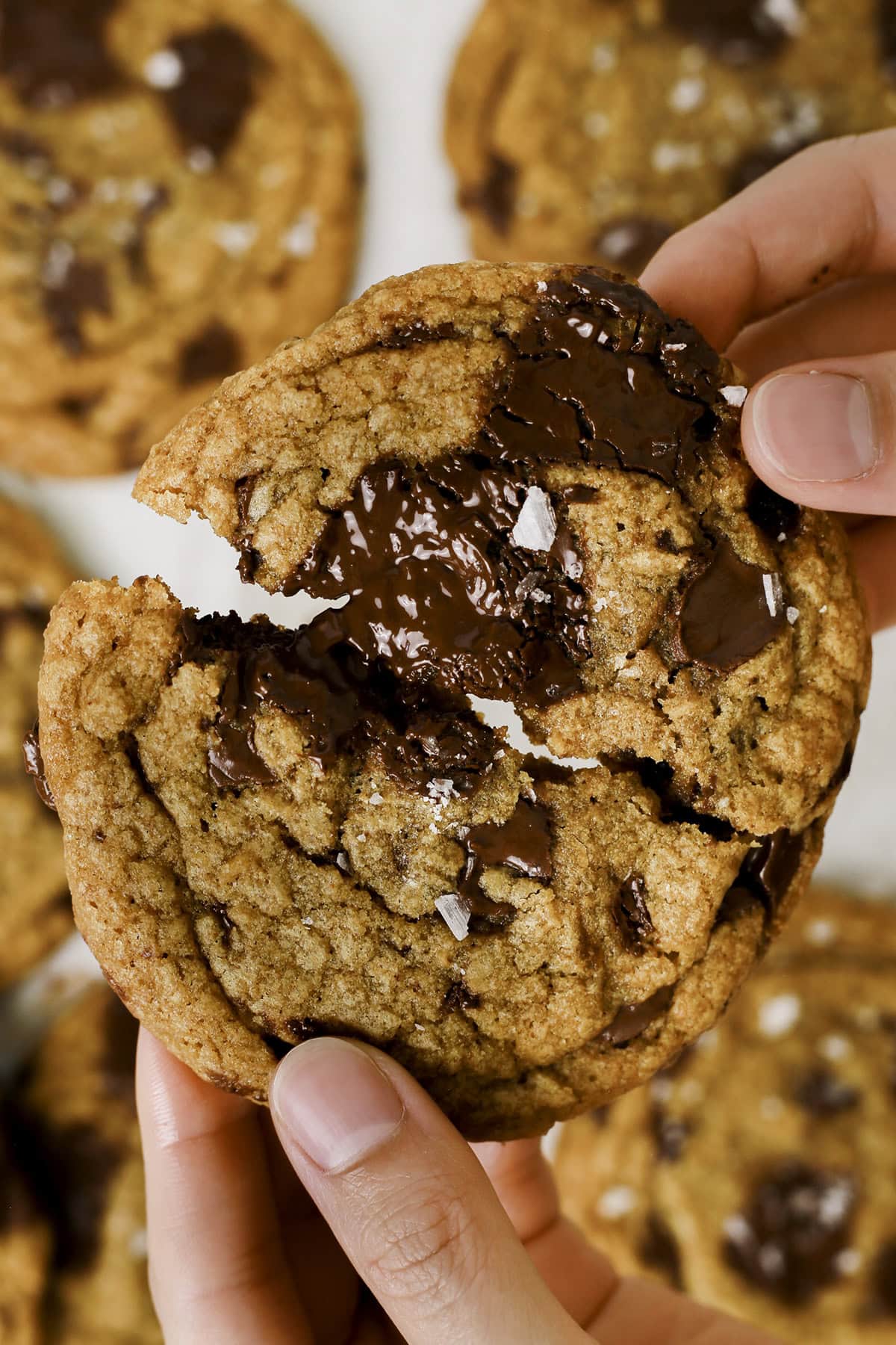 Breaking open a brown butter chocolate chip cookie.