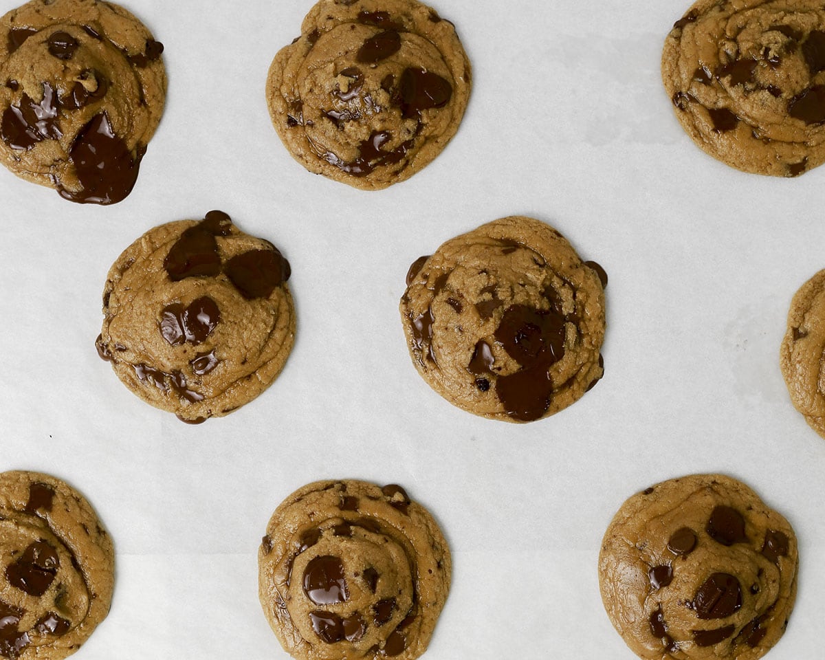 Brown butter chocolate chip cookies mid way through baking, after being tapped.