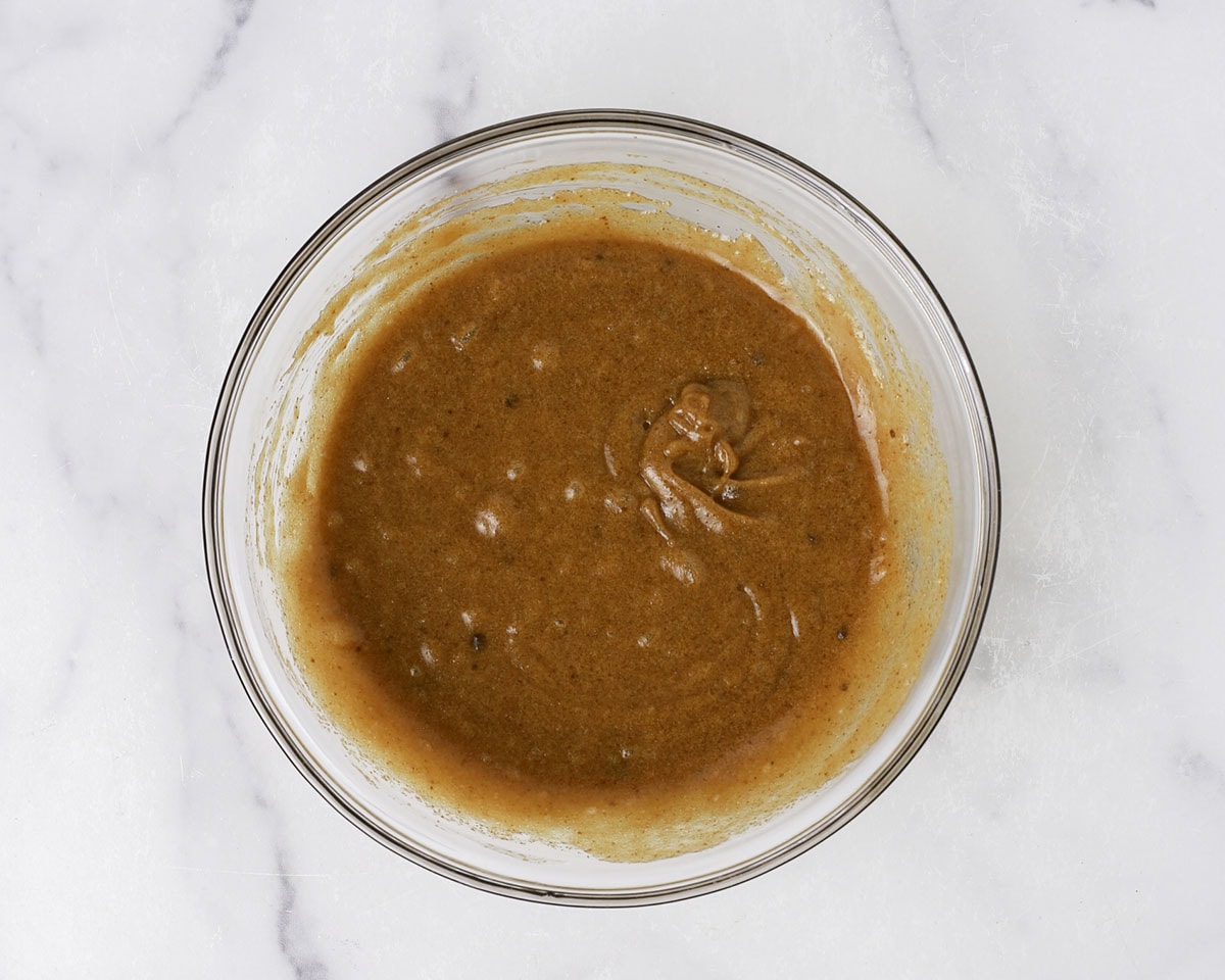 Wet ingredients for the brown butter chocolate chip cookies whisked together in a bowl.